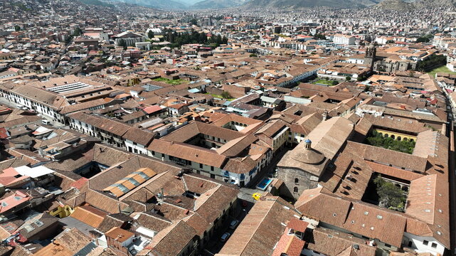 Aerial view of the historic city of Cusco, showcasing dense terracotta rooftops, colonial architecture, courtyards, and narrow streets in Cusco, Cusco, Peru.
