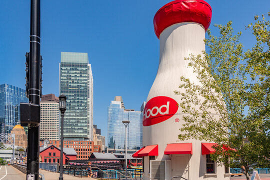 Boston, MA, US-July 11, 2026: The iconic Hood Milk Bottle in South Boston in the Seaport district with Fort Point Channel in foreground and the Boston Tea Party Museum in background.