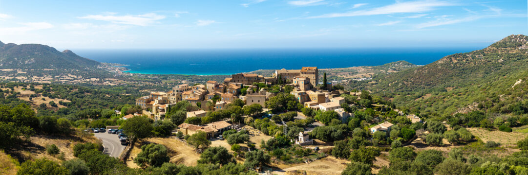Pigna Corsica island aerial drone authentic hilltop village with traditional red roof houses Balagne sea view panorama travel destination. most beautiful villages of France