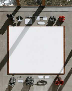 Blank white board centered in a wooden ski rental rack, featuring crisp shadows and professional winter gear for a seasonal mockup and copy space