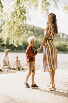 Joyful moments by the lakeside with family and playful kids