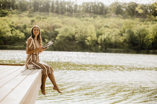 Relaxing by the serene lakeside while enjoying a good book in the sun