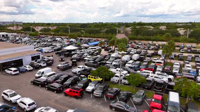 Aerial video dealer parking lot full of Jeeps