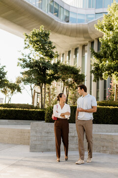Couple enjoys a sunny afternoon walk in a modern urban setting