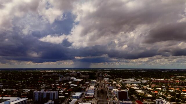 Aerial sped up video of storm clouds moving over a suburban town