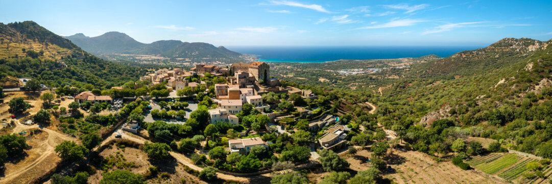 Pigna Corsica France aerial drone 7k panorama hilltop village traditional red roof houses Balagne sea view panorama travel destination most beautiful village world print