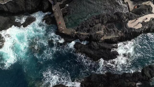 Aerial drone view of the natural lava pools of El Calet&oacute;n in Garachico, northern Tenerife, Canary Islands, Spain. Scenic flight over volcanic rock formations, ocean pools and the rugged Atlantic coast