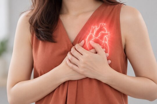 Woman holding chest with heart pain concept