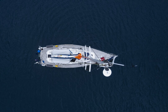 Isles, England, United Kingdom - 07 June 2022: Aerial view of a sailboat navigating the deep blue waters.