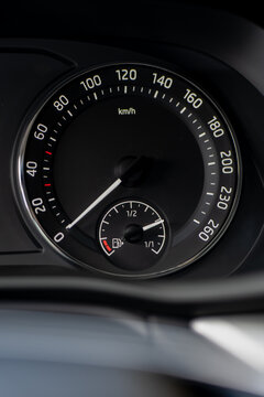 Vehicle dashboard dial combines a road speed scale with a fuel level indicator, showing analog instrumentation used to monitor driving speed and remaining fuel
