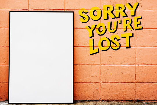 Blank poster mockup on peach brick wall with sorry you're lost text
