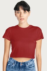 Obraz premium Young woman in red crop top and jeans on white background