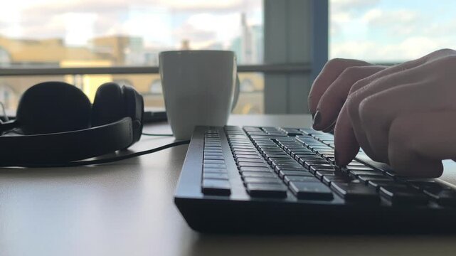 Close-up of hands typing on a computer keyboard. Concept of work, technology, communication and modern digital lifestyle.