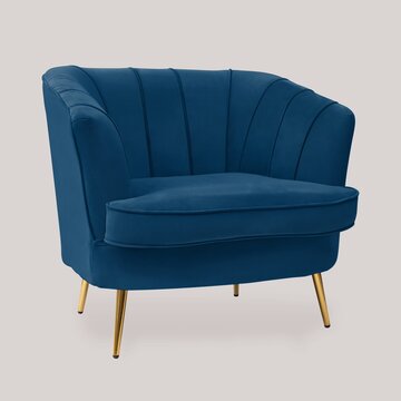 Blue velvet accent chair with gold legs on neutral background