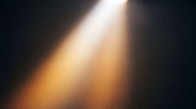 A single bright beam of warm light shining diagonally through a dark and empty space atmosphere