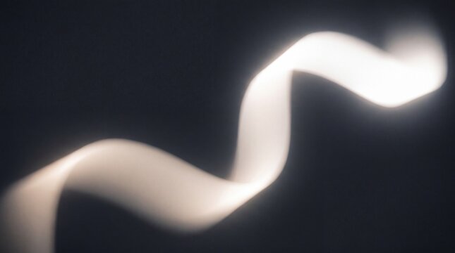 Soft white glowing wavy line floating against a dark and moody blurred background surface