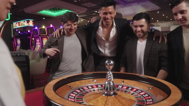 Commercial footage of roulette and baccarat being played by the players surrounded by modern casino gaming machines.