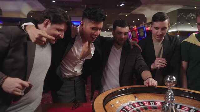 Commercial footage of group of casino players playing roulette game and capturing the real moment of winning and fun night.