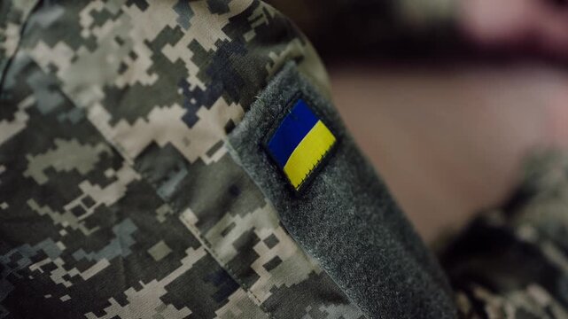 Soldiers in Ukraine with national flag patches on their uniforms during training sessions