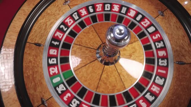 Close-up casino footage showcasing roulette game, numbered pockets and betting chips. Roulette wheel turning during casino play.