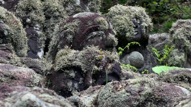 Moss covered stone rakan disciple statues at the Otagi Nenbutsu-ji Temple in Kyoto, Japan