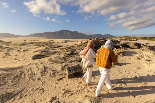 young women wrapped in scarves walking Sopies Klip, Walker Bay Nature Reserve, Stand South Africa at sunset