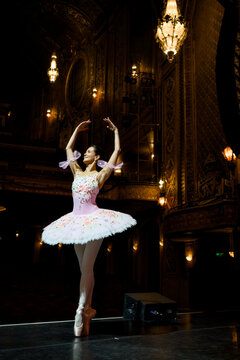 Ballerina en pointe on an ornate theater stage
