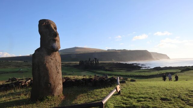 Moai Statues at Ahu Tongariki at Sunset on Easter Island, Rapa Nui, Chile. Time lapse of Moai statues at Ahu Tongariki silhouetted against a dramatic sunset sky.