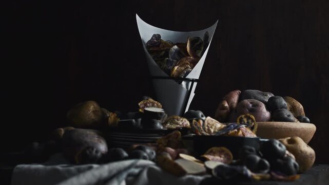 Assorted native Peruvian potatoes and purple chips in a rustic setting.