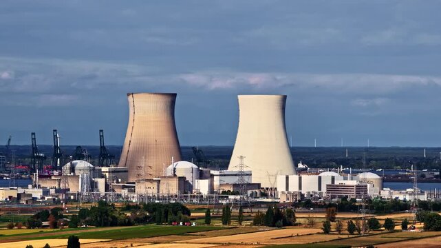 A Nuclear Power Plant With Two Cooling Towers and industrial Infrastructure in Antwerp, Belgium - Pan Down Shot