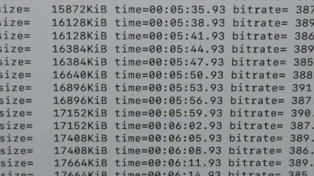 Computer display shows continuously updating bitrate, file size and time values during an active digital encoding process, illustrating media processing and technical computing.