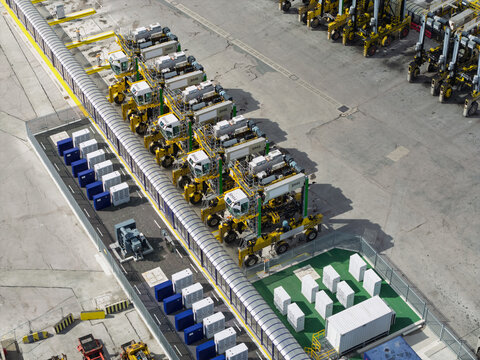 Automated Straddle Carriers Parked at a Container Terminal During Daylight Hours in a Logistics Port