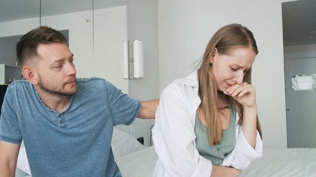 Young man comforts and supports his upset girlfriend while she cries during emotional moment at home. Couple relationship, emotional support, empathy, communication, relationship problems, stress