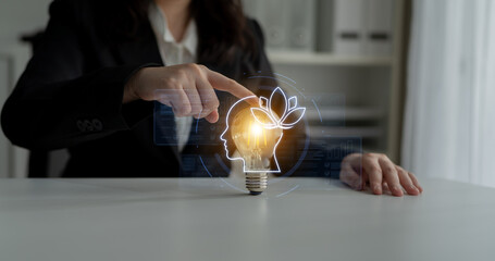 A business professional engages with advanced digital concepts, using a light bulb symbolizing ideas and growth, while illustrating creativity and innovation in a modern workspace. Nascent © InfiniteFlow