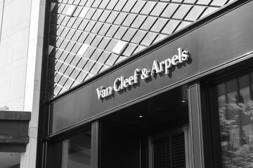 Fototapeta premium black and white view of exterior building facade and sign of Van Cleef & Arpels, a jewelry store, located at 100 Bloor St W, Toronto