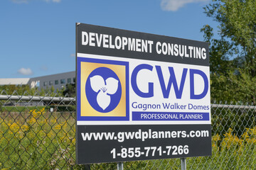 Fototapeta premium GWD (Gagnon Walker Domes) development consulting sign on a wire mesh fence, Eglinton Av E, Toronto