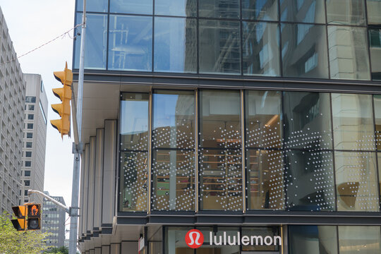 exterior building facade and sign of lululemon, a sportswear store, located here at 2 Bloor St W, Toronto