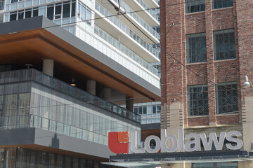 Obraz premium corner with sign of Loblaw Grocerteria former headquarters and warehouse now the West Block development located at 500 Lake Shore Blvd W, northeast corner of Bathurst St, Toronto