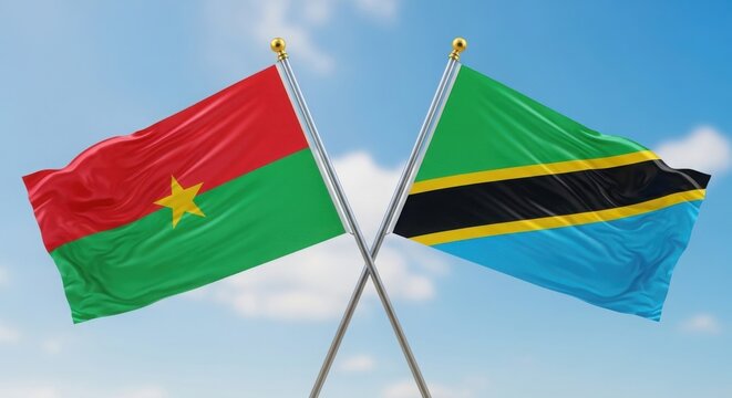 Burkina Faso and Tanzania flags crossed against a clear blue sky illustration