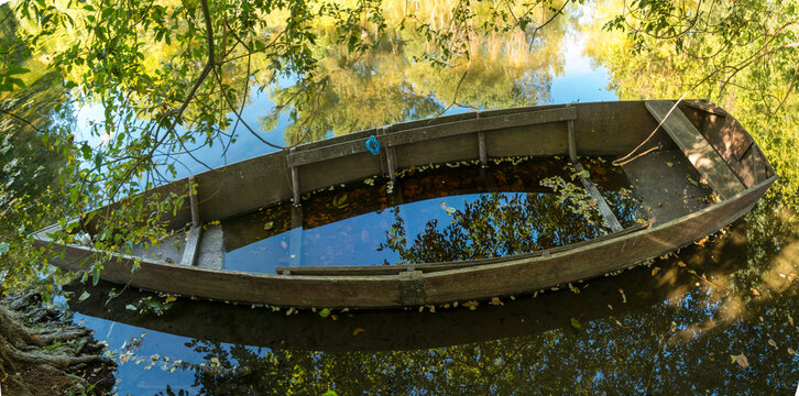 France, Dordogne, Carennac.  Sunken small watercraft on the side of the Dordogne River.