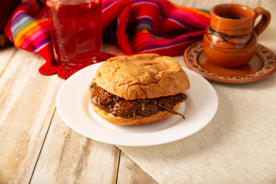 Hojaldra de Mole. Authentic Mexican mole pastry sandwich on a rustic background. Tasty food photography with copy space. Mexican homemade food.