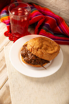 Hojaldra de Mole. Authentic Mexican mole pastry sandwich on a rustic background. Tasty food photography with copy space. Mexican homemade food.