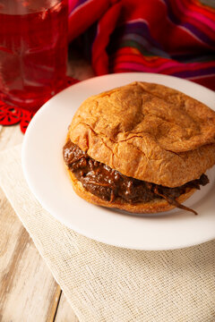 Hojaldra de Mole. Authentic Mexican mole pastry sandwich on a rustic background. Tasty food photography with copy space. Mexican homemade food.