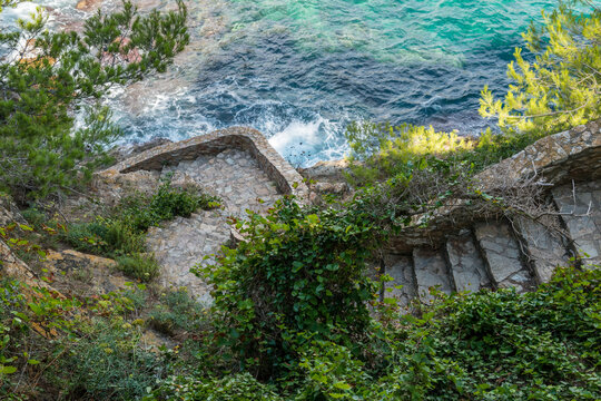 Spain, Catalonia, Costa Brava, Sa Tuna.  Coastal footpath with many stairs.