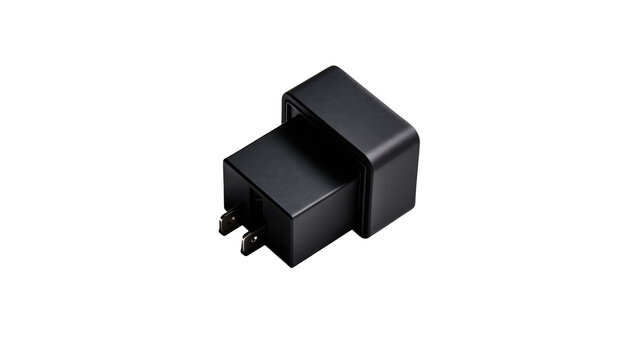 Isolated black plastic electrical adapter or automotive relay with two prongs, studio shot.