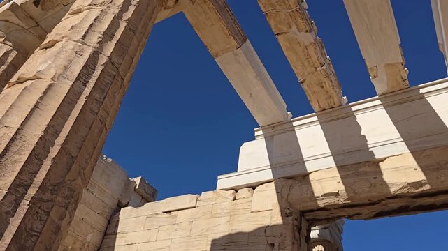 Propylaea, Acropolis, Athens, Greece - 26 June 2026. Upward view beneath the gateway showing marble crossbeams, coffered ceiling panels, restored blocks and a small opening to blue sky.