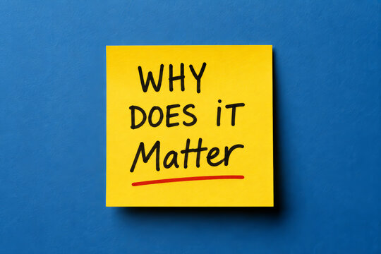 Yellow sticky note with why does it matter text on a blue background for motivation.