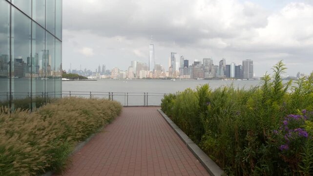 New York City Manhattan Downtown skyline from Liberty Island, United States. Financial District cityscape, World Trade Center skyscraper tower. Building architecture. Rainy cloudy autumn fall weather.