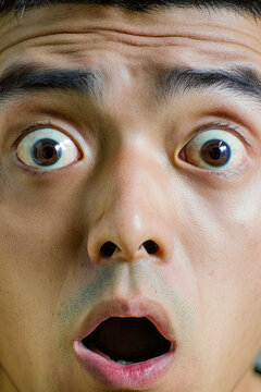 A man with a surprised look on his face. vertical frame