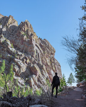 Woman looking out at cliff face in Eldorado Canyon Colorado 